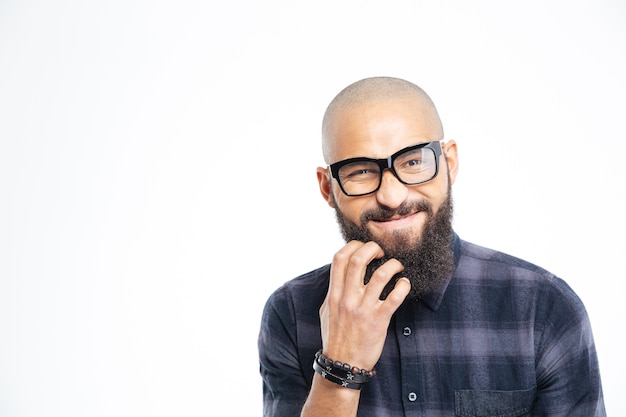 Closeup of handsome baldheaded young african american man in glasses scratching his beard