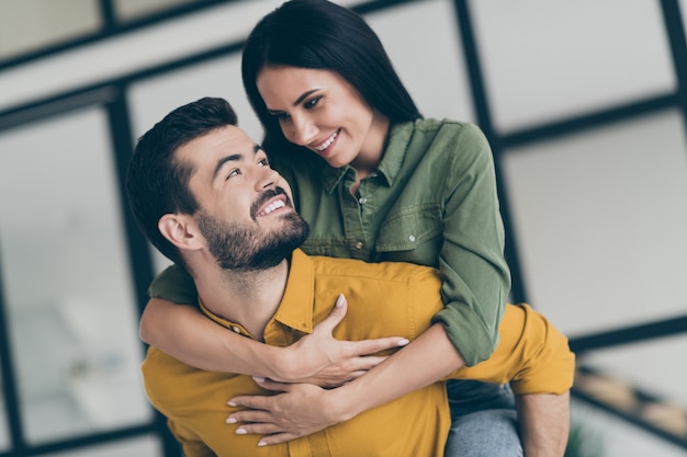 Closeup   handsome husband guy and his wife lady spending honeymoon in modern luxury country penthouse flat holding piggyback