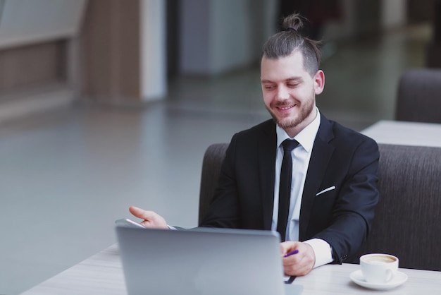 Closeup happy businessman sitting at his Desk