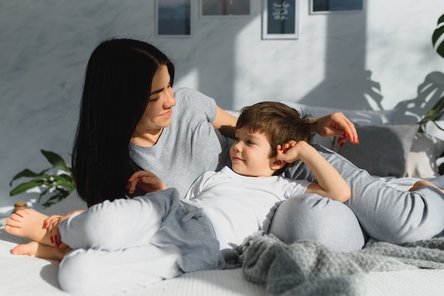 Closeup of happy family playing over the bed in a relaxed morning.