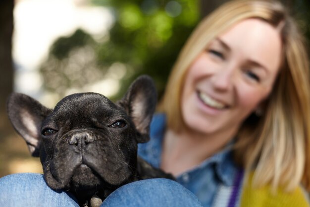 Closeup on happy young woman with dog outdoors in autumn