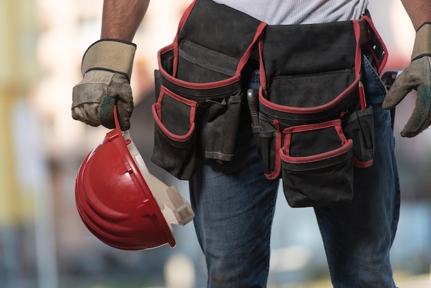 CloseUp Of Hard Hat Holding By Construction Worker