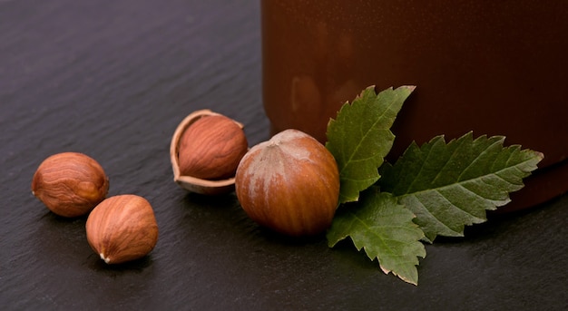 Photo closeup of hazelnuts, clipping path included on the black wood table