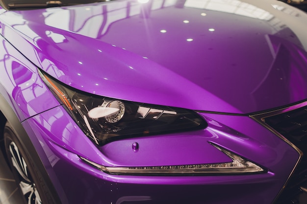 Closeup headlights of car Violet body close-up. 