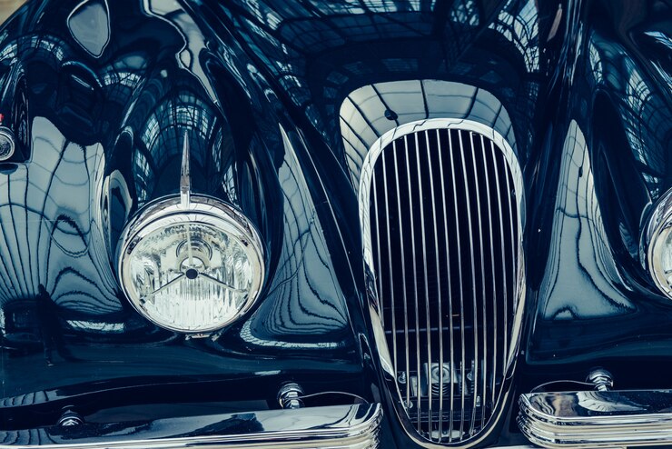 Photo closeup of the headlights and front bumper on vintage automobile