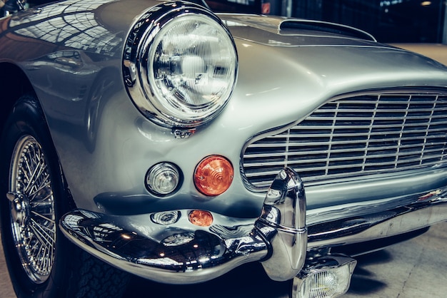 Closeup of the headlights and front bumper on  vintage automobile