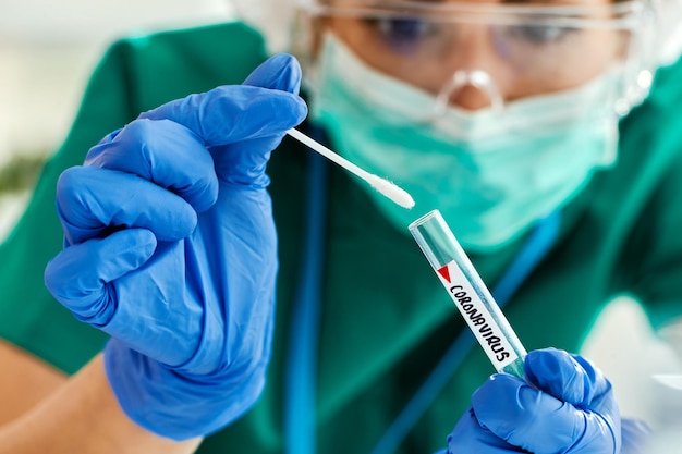 Closeup of healthcare expert examining coronavirus test sample in the laboratory