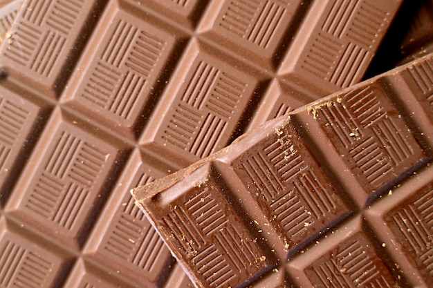 Closeup heap of cracked chocolate bar with selective focus