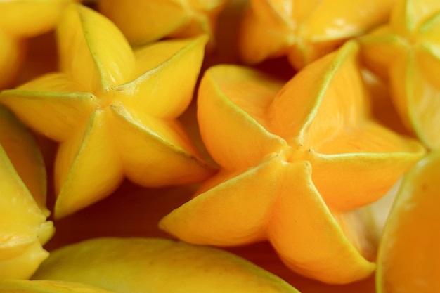 Closeup a Heap of Fresh Ripe Vibrant Yellow Star Fruits or Carambola