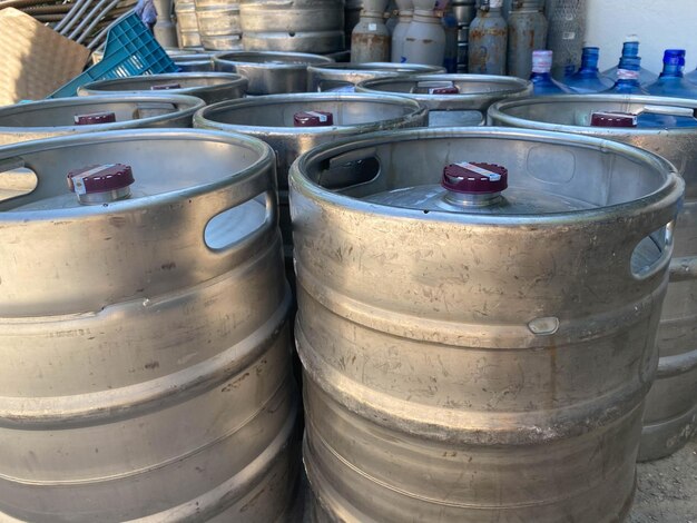 Closeup heap of shiny stainless steel beer kegs