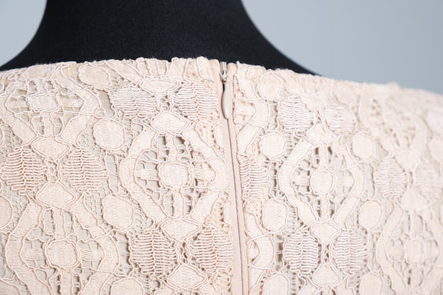 Photo closeup of the hidden zipper on a beige lace dress