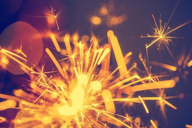 Closeup of holiday christmas sparkler on dark background