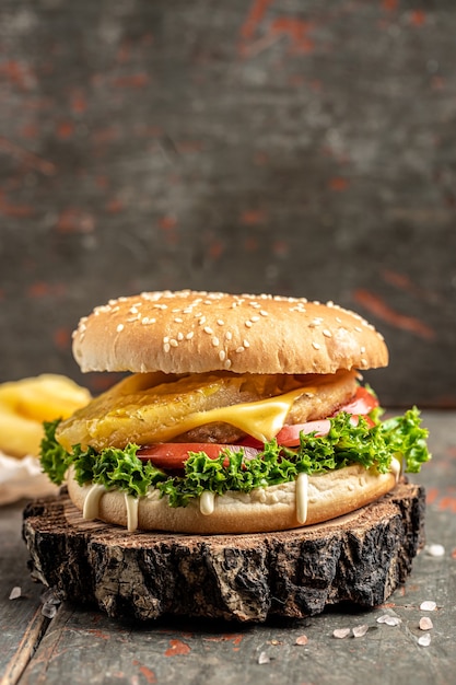 Closeup of home made burger on wooden background. take out or delivery foods
