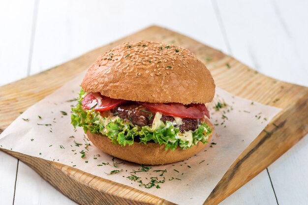 Closeup of home made burger on wooden board