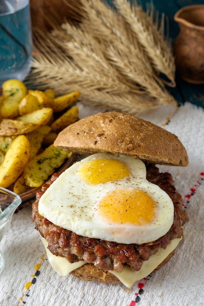 Closeup of home made burger on wooden