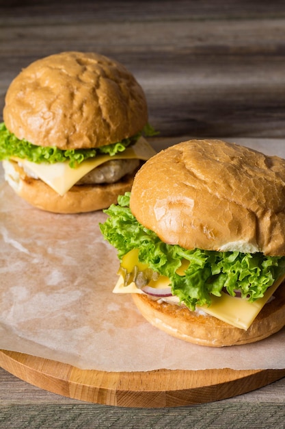 Closeup of home made tasty burgers on wooden table