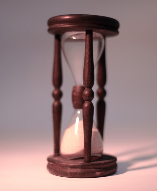 Closeup of hourglass isolated on blue background