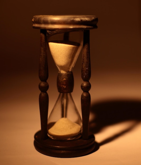 Closeup of hourglass isolated on blue background