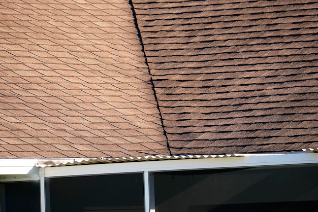 Closeup of house roof top covered with asphalt or bitumen shingles Waterproofing of new building