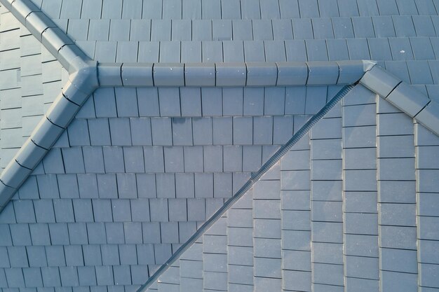 Closeup of house roof top covered with ceramic shingles Tiled covering of building