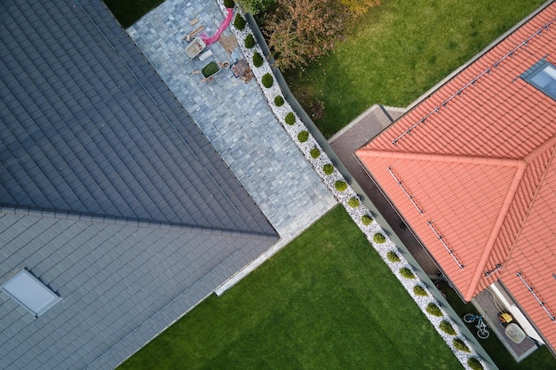 Closeup of house roof top covered with ceramic shingles Tiled covering of building