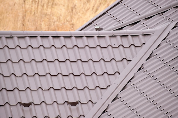 Closeup of house roof top covered with metallic shingles