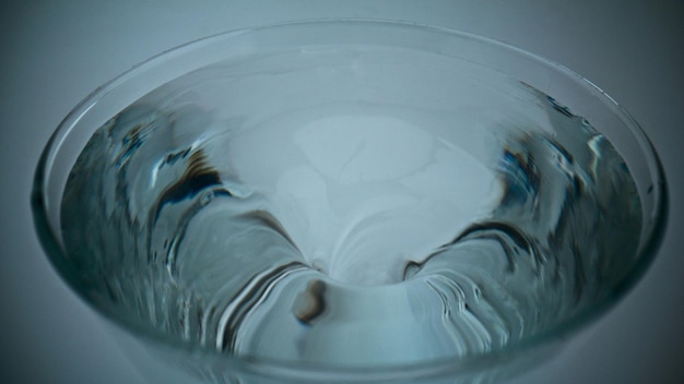 Closeup ice aqua making funnel inside glassware Container with rotating liquid