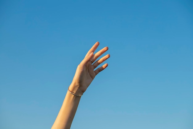 Closeup image of beautiful woman's hands with light pink manicure on the nails. Skin care for hands,