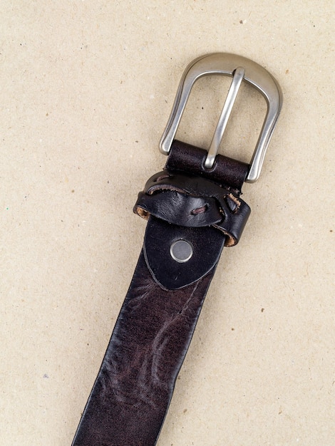 Photo a closeup image of a belt for trousers and a skirt on a paper background