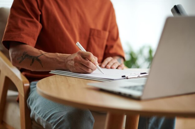 Closeup image of blogger working on script for his blog