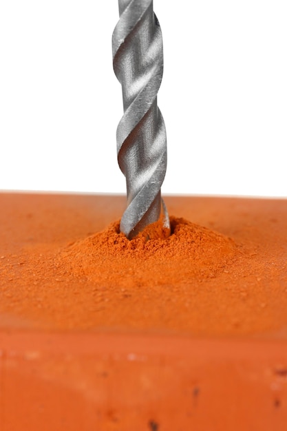 Closeup image of drilling hole on brick isolated on a white