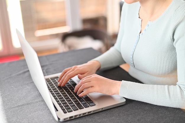 Closeup image of female hands typing on a laptop Businesswoman text response to client email buye