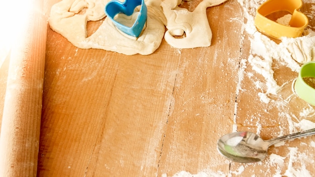 Closeup image of lots of ingredients and kitchen tools for cooking and bakery on wooden desk