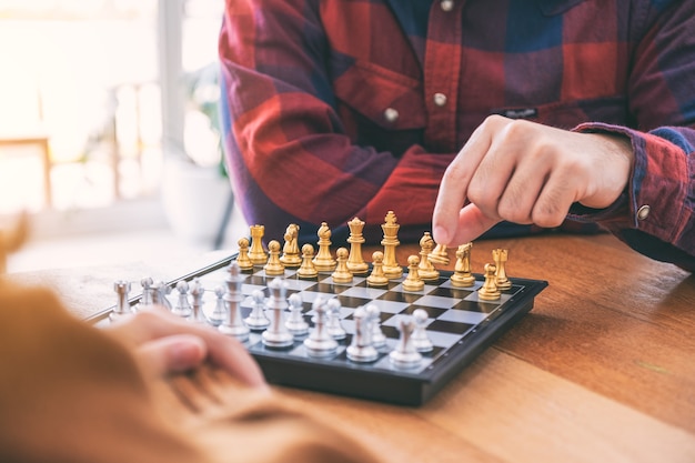 Closeup image of a man moving and playing chessboard game together