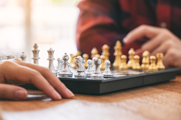 Closeup image of a man moving and playing chessboard game together