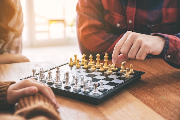 Closeup image of people moving and playing chessboard game together