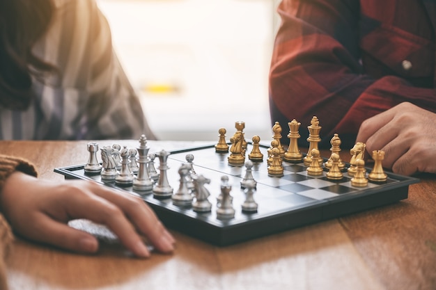 Closeup image of people playing chessboard game together