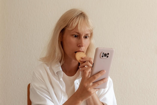 Крупным планом изображение красивой женщины, сидящей в уютном домашнем интерьере и использующей современный смартфон, женские руки печатают текстовое сообщение через концепцию социальных сетей мобильного телефона