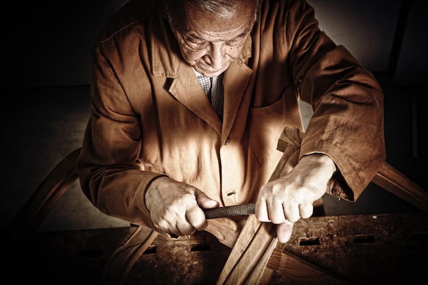 Closeup image on senior carpenter at work