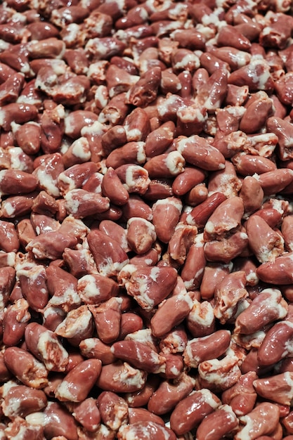 Photo closeup image showcasing a texture made entirely of raw chicken hearts suitable for food industry