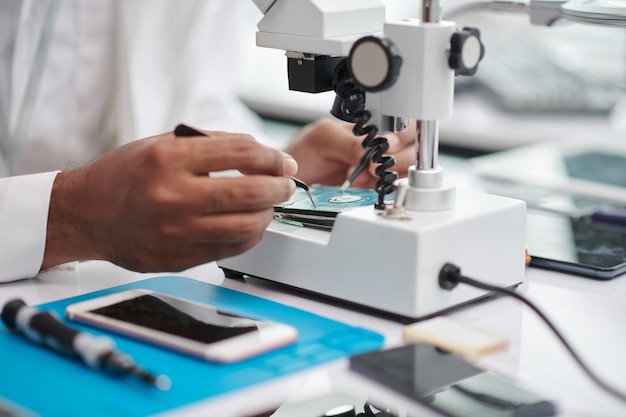 Closeup image of technician repairing hard drive