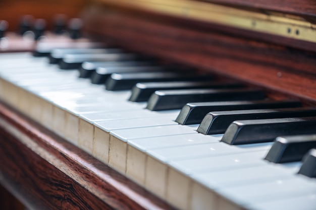 Closeup image of a vintage wooden grand piano