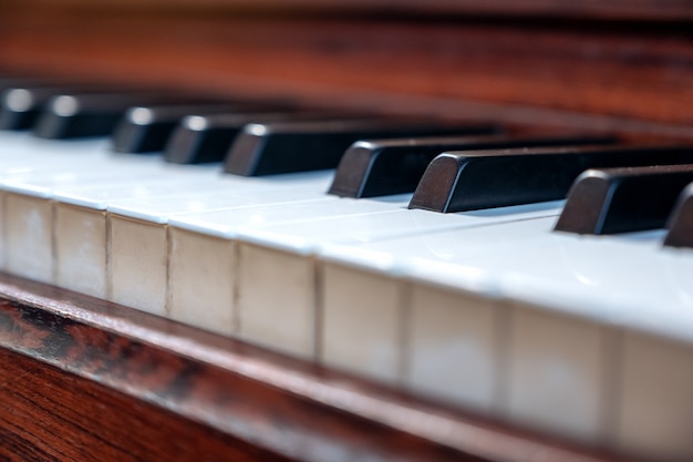 Closeup image of a vintage wooden grand piano