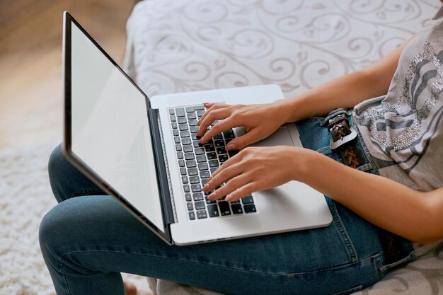 Closeup image of woman hands keyboarding on netbook with blank copy space screen for text message