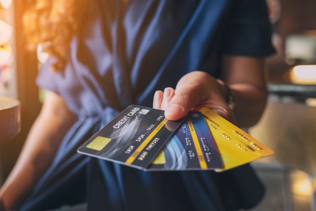 Photo closeup image of a woman holding and showing credit cards
