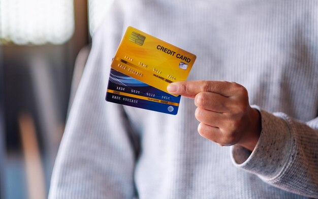 Closeup image of a woman holding and showing credit cards