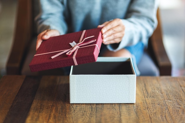 Closeup image of a woman opening a gift box