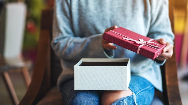 Closeup image of a woman opening a gift box