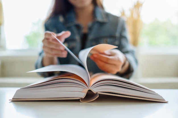 Closeup image of a woman opening and reading book