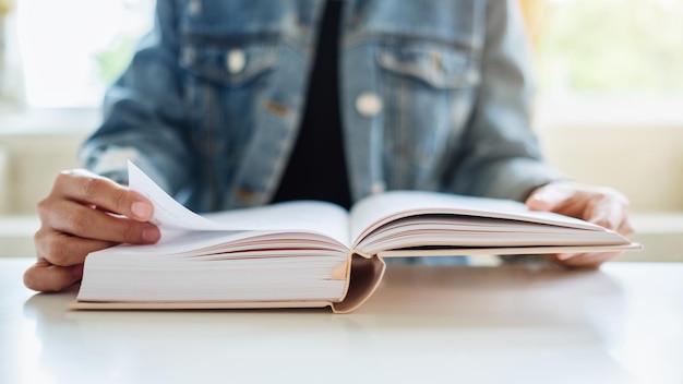 Closeup image of a woman sitting and reading book